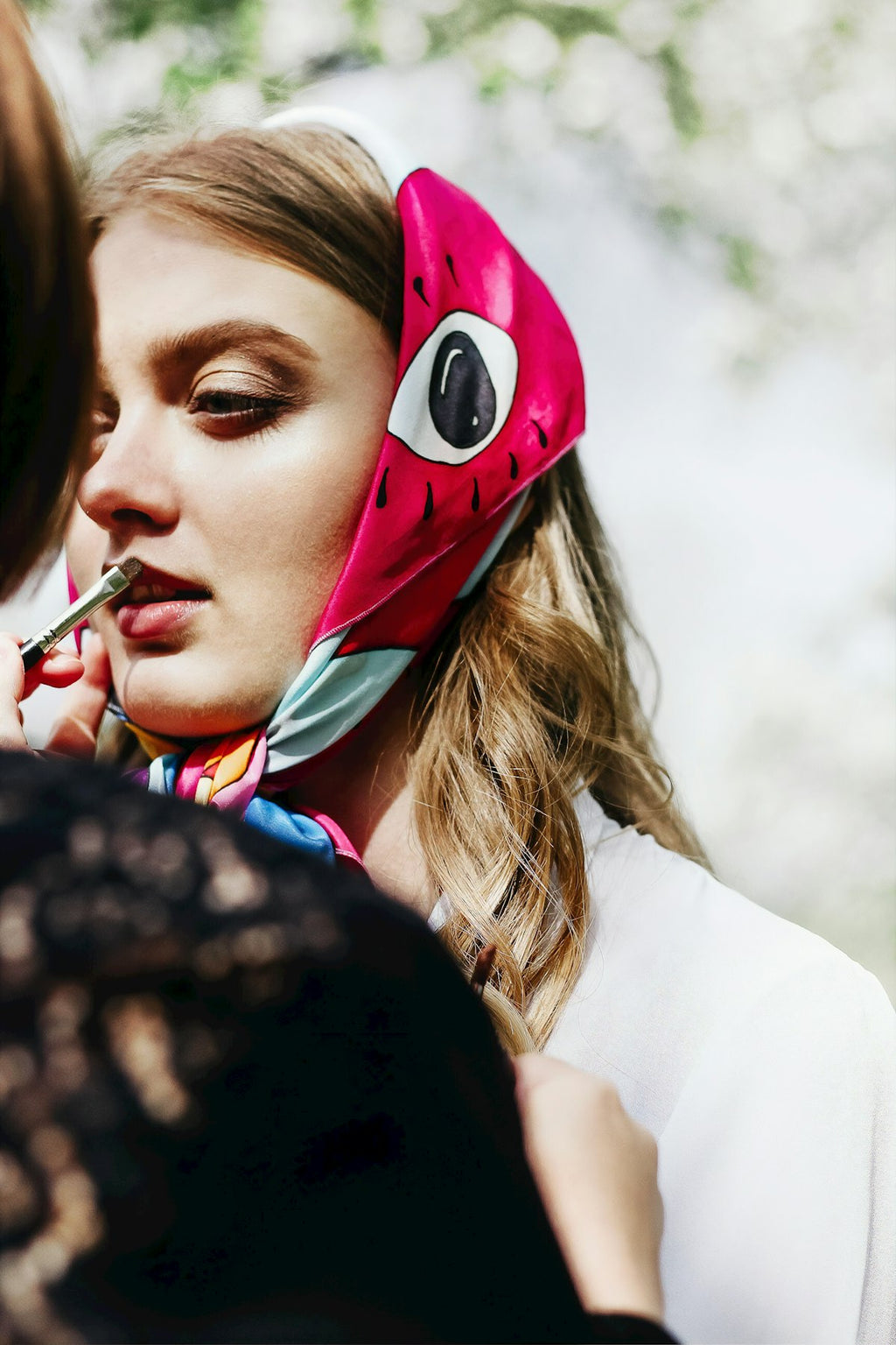Woman wearing a printed silk-touch scarf