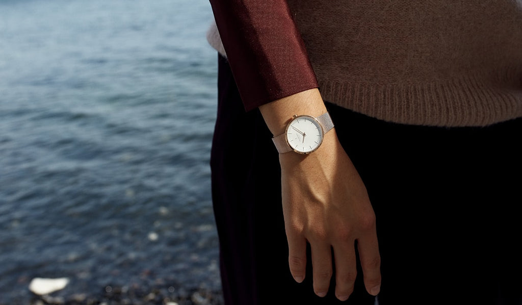 Minimalist white watch worn with casual outfit