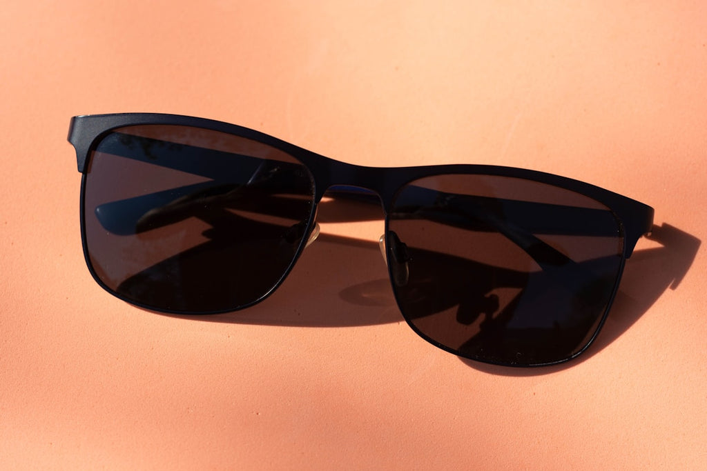 Black oversized square sunglasses on white surface